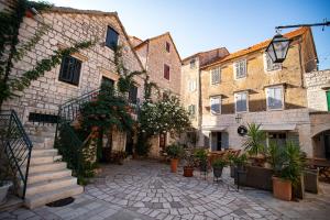an alley in an old town with buildings at Waterfront Villa Antica, Cheerful 8 bedrooms with pool-Luxury is personal in Stari Grad