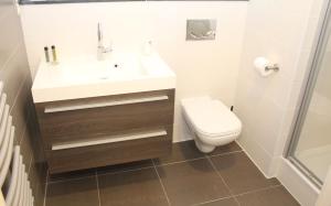 a bathroom with a sink and a toilet at Mondo hôtel in Tubize +18 photos