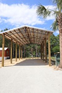 a wooden pavilion with a palm tree at Truth Harbors RV Spot 30-50 amp in Steinhatchee
