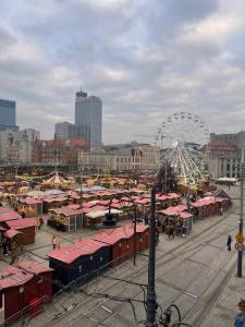 a city with a carnival and a ferris wheel at LivingRoom 2 z wanną z hydromasażem in Katowice