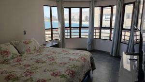 a bedroom with a bed and a view of a pool at DEPTO SUITE II in Iquique