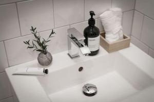 a bottle of wine sitting on a bathroom sink at Fully furnished room for rent in Märsta in Märsta