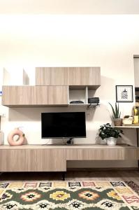 a living room with a flat screen tv on a entertainment center at Carducci apartment in Palermo