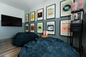 a bedroom with two beds and posters on the wall at voco The Darwin - Atlanta Midtown by IHG in Atlanta