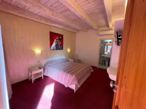 a bedroom with a bed and a painting on the wall at Bel Sole Guest House in Civitavecchia