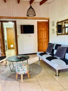 a living room with a couch and a table at Casa El Arrebol, sector Saltos del Laja in Cabrero