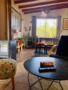 a living room with a table and chairs at Casa El Arrebol, sector Saltos del Laja in Cabrero