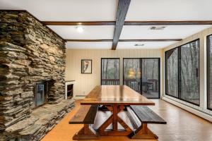 a wooden table in a room with a stone wall at Woodward Grove in Plymouth