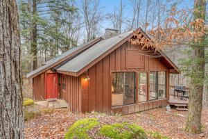 a small wooden cabin in the woods with trees at Woodward Grove in Plymouth