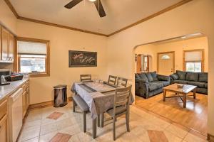 a kitchen and living room with a table and a couch at All-Season Grand Haven Getaway with Deck! in Grand Haven