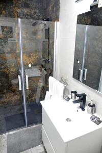 a bathroom with a white sink and a shower at River Dreams in Deltebre