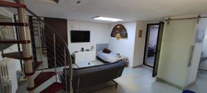 sala de estar con sofá y escalera en Central private flat by old town, shops, restaurants, en Bari