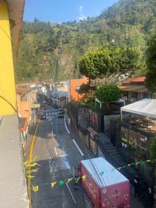 a city street with a mountain in the background at Hostal Maria Mercedes in Baños