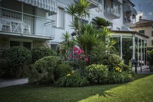 a garden in front of a building with flowers and plants at Hotel Riviera Blu in Tirrenia