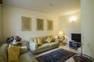 a living room with a couch and a tv at Hotel Riviera Blu in Tirrenia