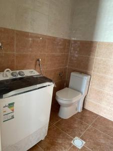 a bathroom with a toilet and a sink at شاليهات لافندر الباحه بلجرشي in Baljurashi