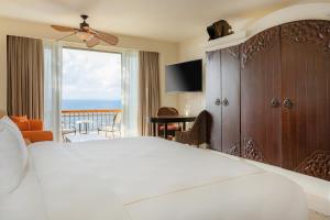 a bedroom with a bed and a view of the ocean at Marquis Los Cabos, an All - Inclusive, Adults - Only & No Timeshare Resort in San José del Cabo
