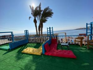 a playground on a balcony with the beach at Dream house in Dahab