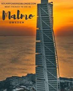 a poster of the malibu skyscraper at sunset at Stella's Home in Malmö
