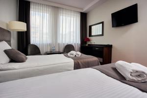 Posteľ alebo postele v izbe v ubytovaní Hotel Maraton