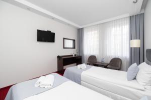 Posteľ alebo postele v izbe v ubytovaní Hotel Maraton