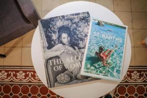 two books sitting on top of a shelf at AmazINN Places Rooftop and Jacuzzi VII in Panama City