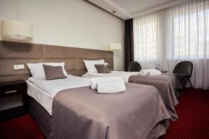 Posteľ alebo postele v izbe v ubytovaní Hotel Maraton