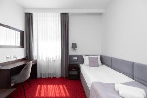 Posteľ alebo postele v izbe v ubytovaní Hotel Maraton