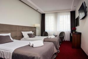 Posteľ alebo postele v izbe v ubytovaní Hotel Maraton