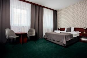 Posteľ alebo postele v izbe v ubytovaní Hotel Maraton