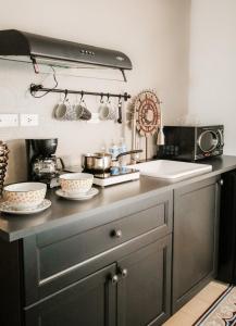 a kitchen with a counter with bowls on it at AmazINN Places Rooftop and Jacuzzi II in Panama City