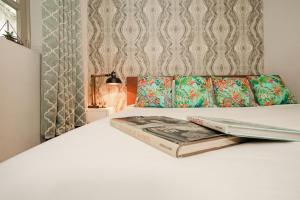 a bedroom with a bed with two books on it at AmazINN Places Rooftop and Jacuzzi II in Panama City +10 photos