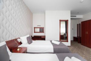 Posteľ alebo postele v izbe v ubytovaní Hotel Maraton