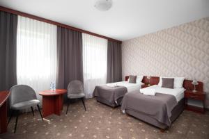 Posteľ alebo postele v izbe v ubytovaní Hotel Maraton