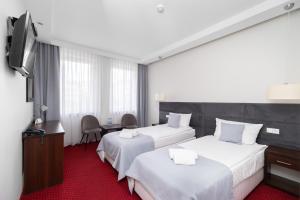 Posteľ alebo postele v izbe v ubytovaní Hotel Maraton