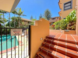 a house with a gate with a swimming pool at Mermaid Beach Park View in Gold Coast
