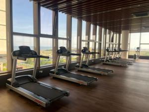 a row of treadmills in a gym with windows at Bali Resident- B-10 in Melaka