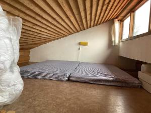 a bed in a room with a wooden ceiling at Holiday home Bedsted Thy III in Bedsted Thy