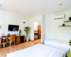 a living room with a bed and a desk at RiverTree Villa & Resort in Kampot