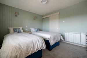 a bedroom with two beds in a room at Castle View Bamburgh in Bamburgh