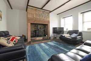 a living room with a couch and a fireplace at Beach Retreat in Seahouses