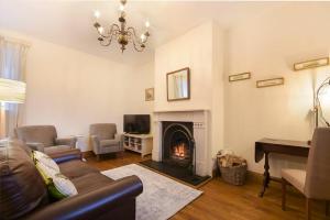 a living room with a couch and a fireplace at No9 Budle Sands in Bamburgh