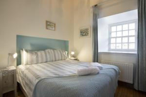 a bedroom with a bed with two towels on it at No9 Budle Sands in Bamburgh