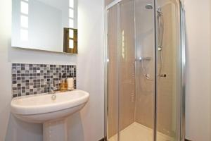 a bathroom with a sink and a shower at Beach Retreat in Seahouses +17 photos