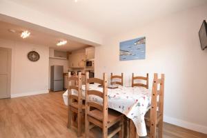 a kitchen and dining room with a table and chairs at Anchor Lodge in Seahouses