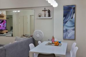 a living room with a white table and a couch at A cozy 2 bedroom condo in Metro in Manila
