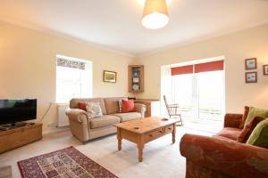 a living room with a couch and a coffee table at Dunrovin in Beadnell