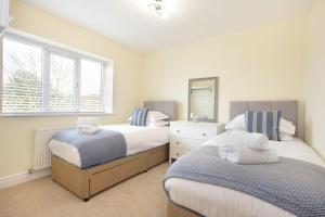 a bedroom with two beds with towels on them at Viewpoint in Alnmouth