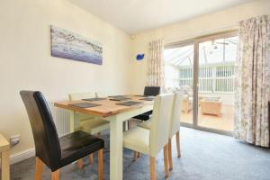 a dining room with a wooden table and chairs at Annstead House in Seahouses