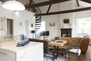 a kitchen and living room with a table and chairs at Treetops, Alnwick in Alnwick